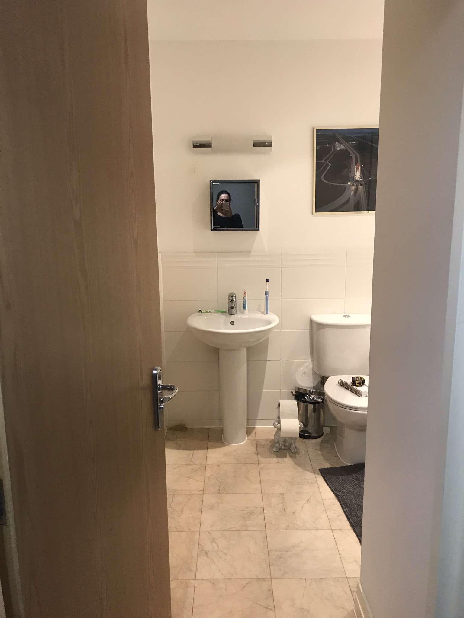 Bathroom before makeover with an old white suite in it and bath