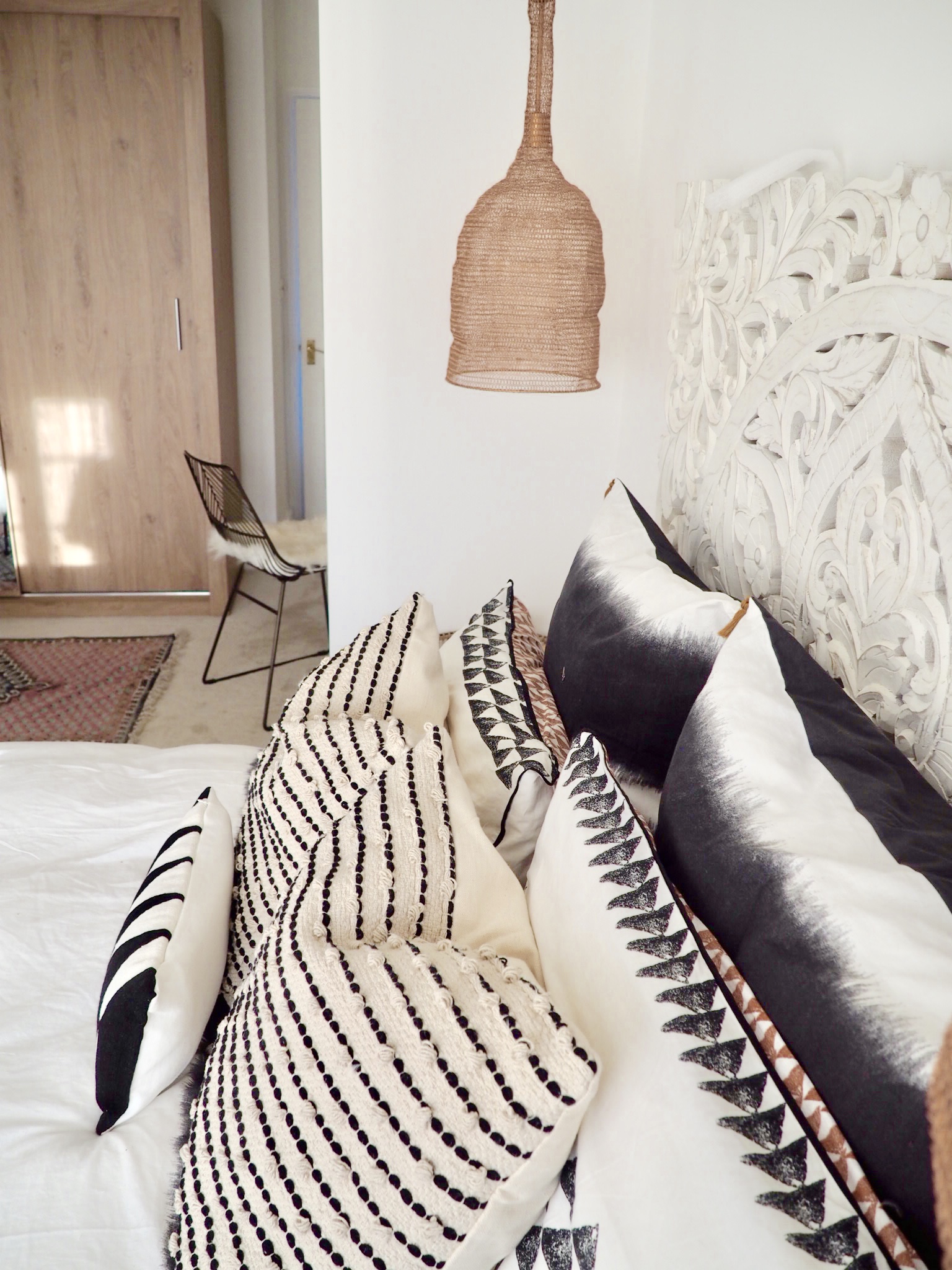 Bedding from La Redoute next to copper mesh pendant lights
