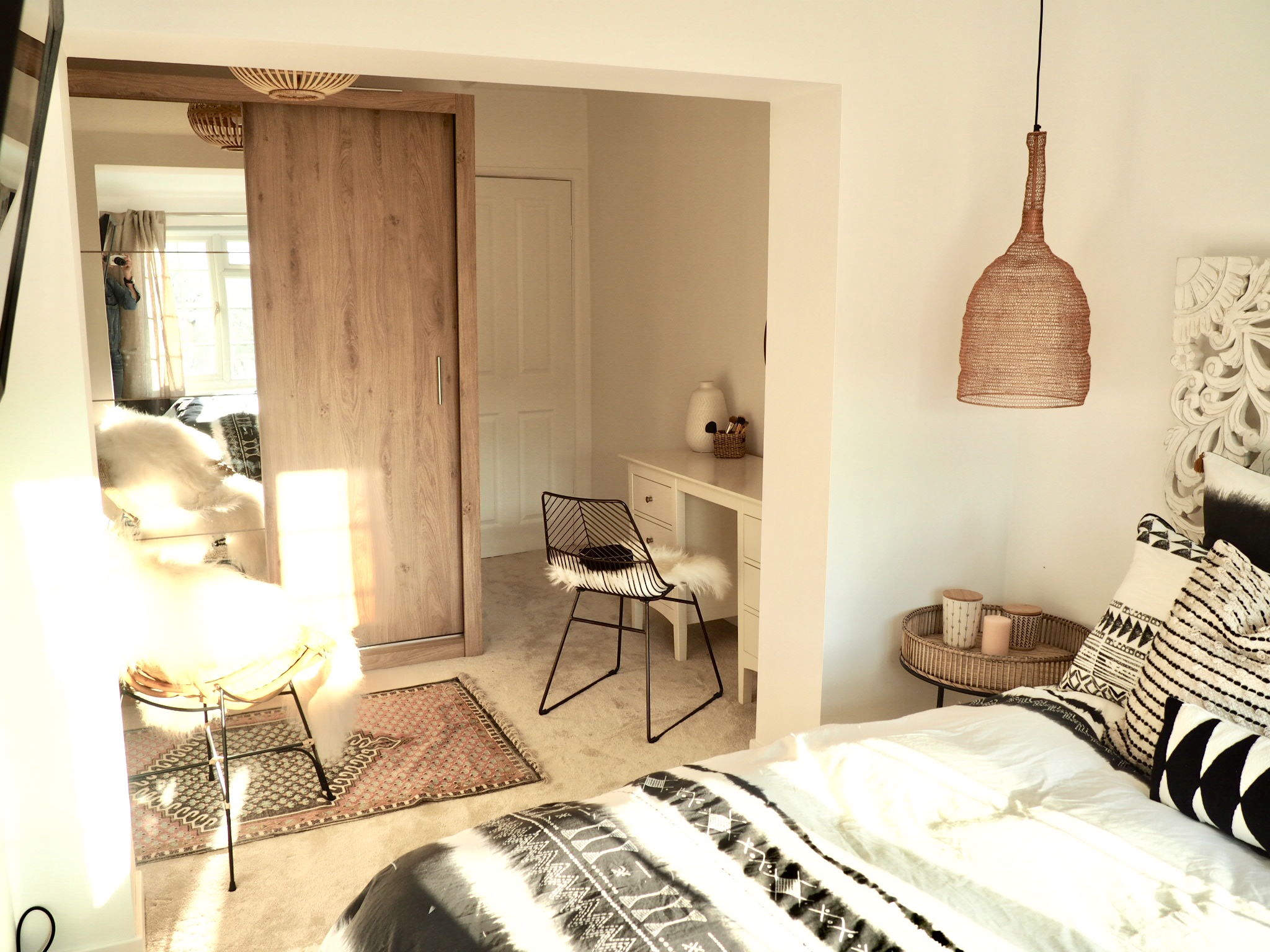 Panoramic room view of the wardrobes, bed and desk in a teenage girl’s bedroom