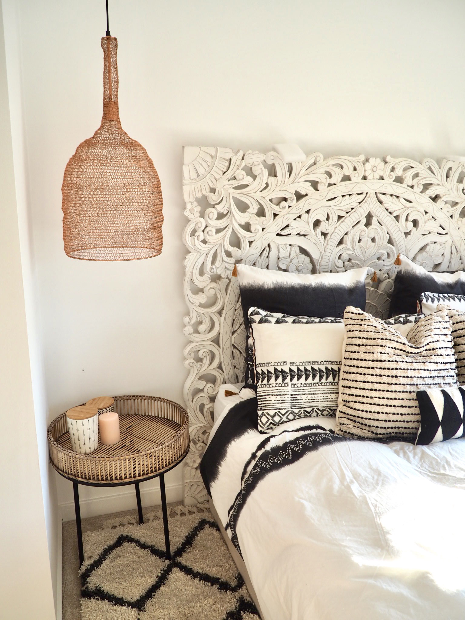 Bedding from La Redoute next to copper mesh pendant lights