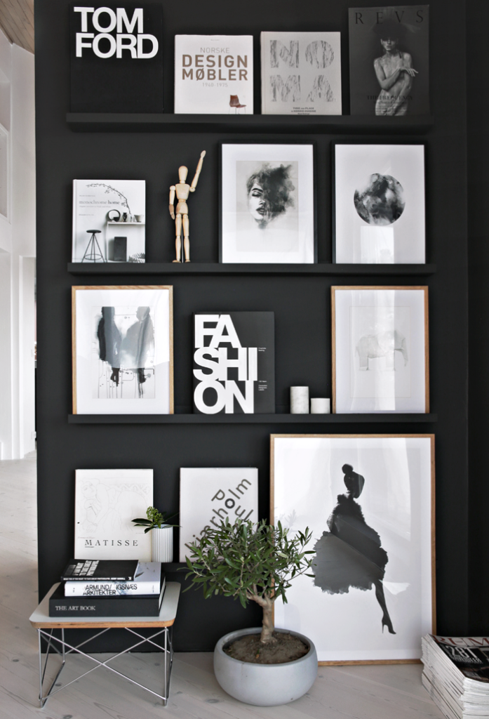 Black feature wall with shelving and art and curios